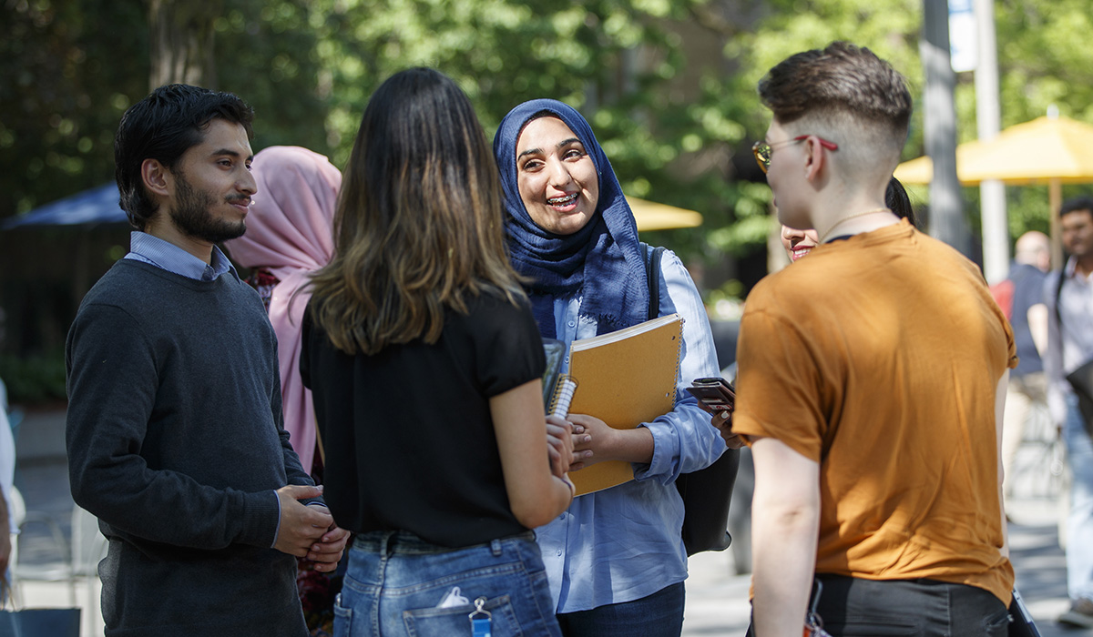 Group of students talking outside the university campus