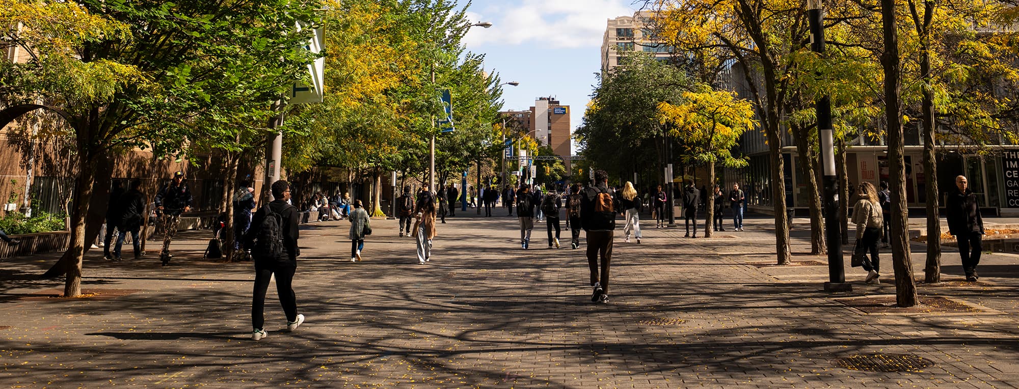 Students walking through the TMU campus walkway during the fall semester.