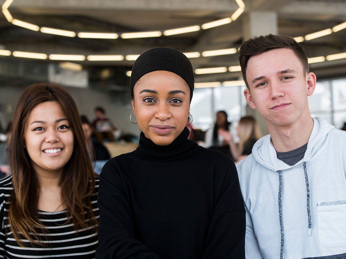 3 diverse students posing for a picture in Ryerson's Student Learning Centre