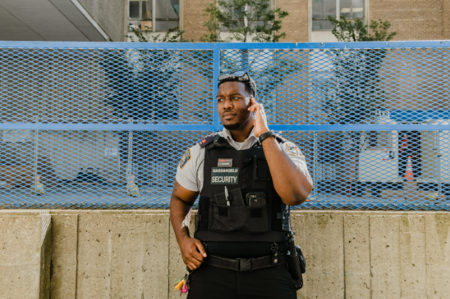 An essential worker at Toronto Metropolitan University taking a phone call