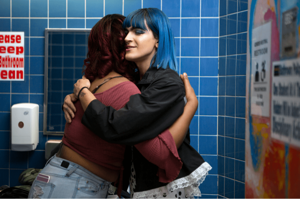 Two non-binary people hugging