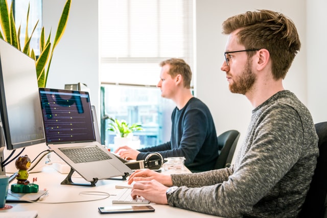 Two men working at computer