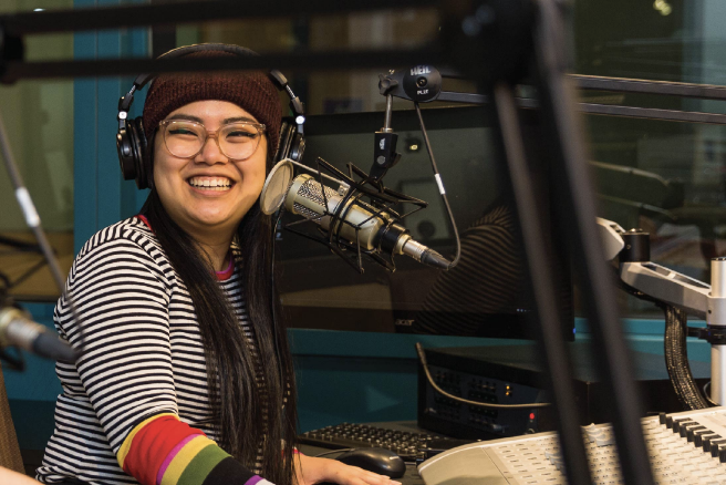 A student recording a podcast. 