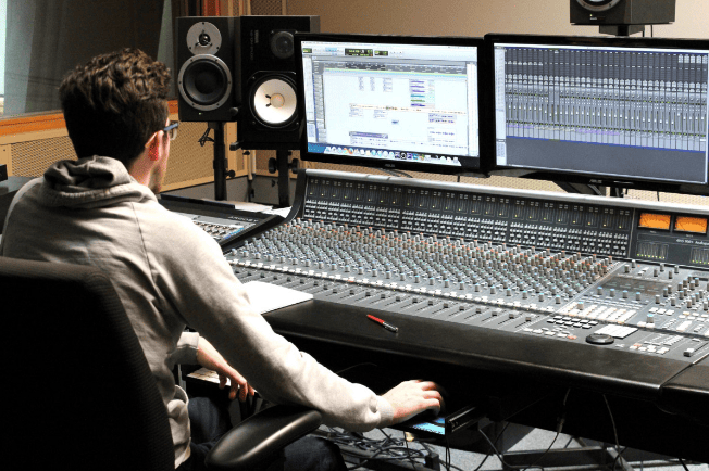 A student in a production studio. 