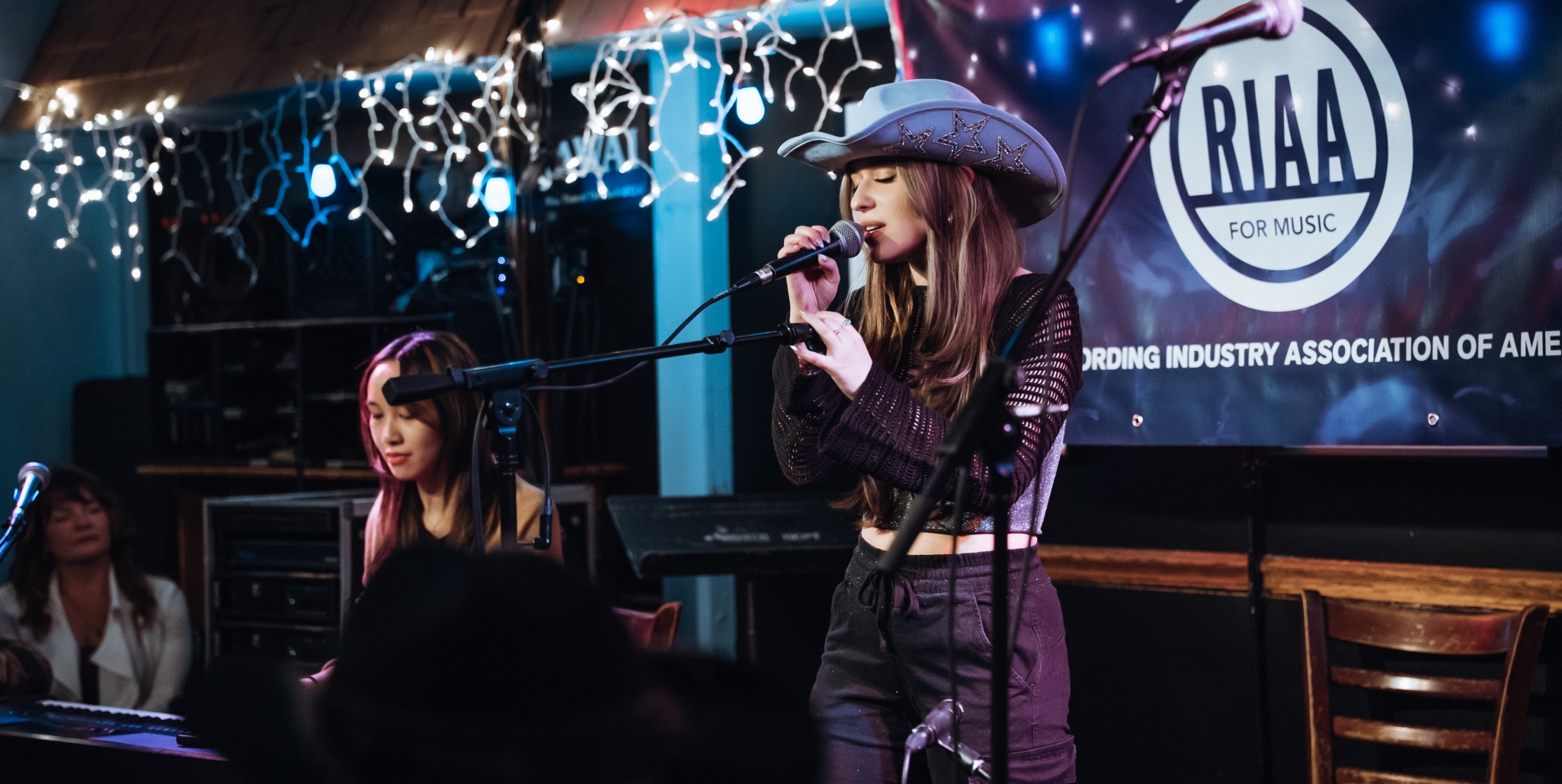 A student performs on stage at an industry event, demonstrating live performance skills.Photo courtesy of Antonio Adams