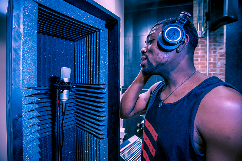 Person recording audio in studio