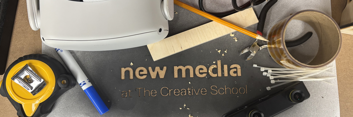 new media stencil surrounded by various tools and making materials