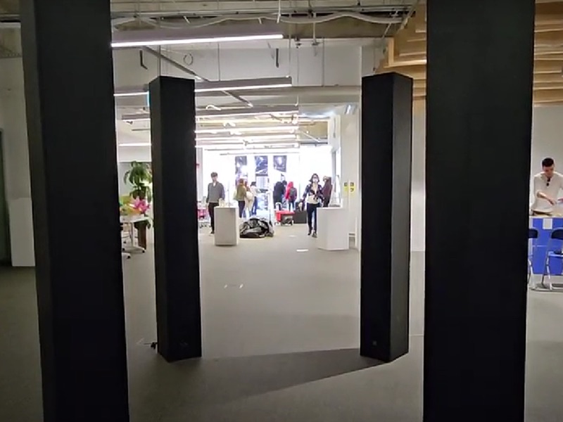 The resonance exhibition in the Catalyst. Four black pillars are set up in a square inside the exhibition space.