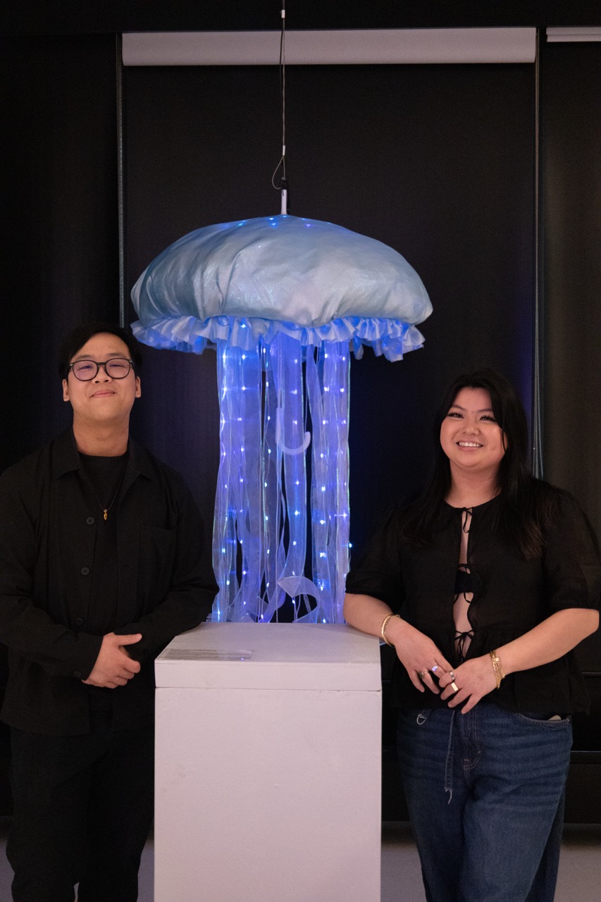Madeline and exhibition partner Alec stand with their light up jelly fish mobile. 
