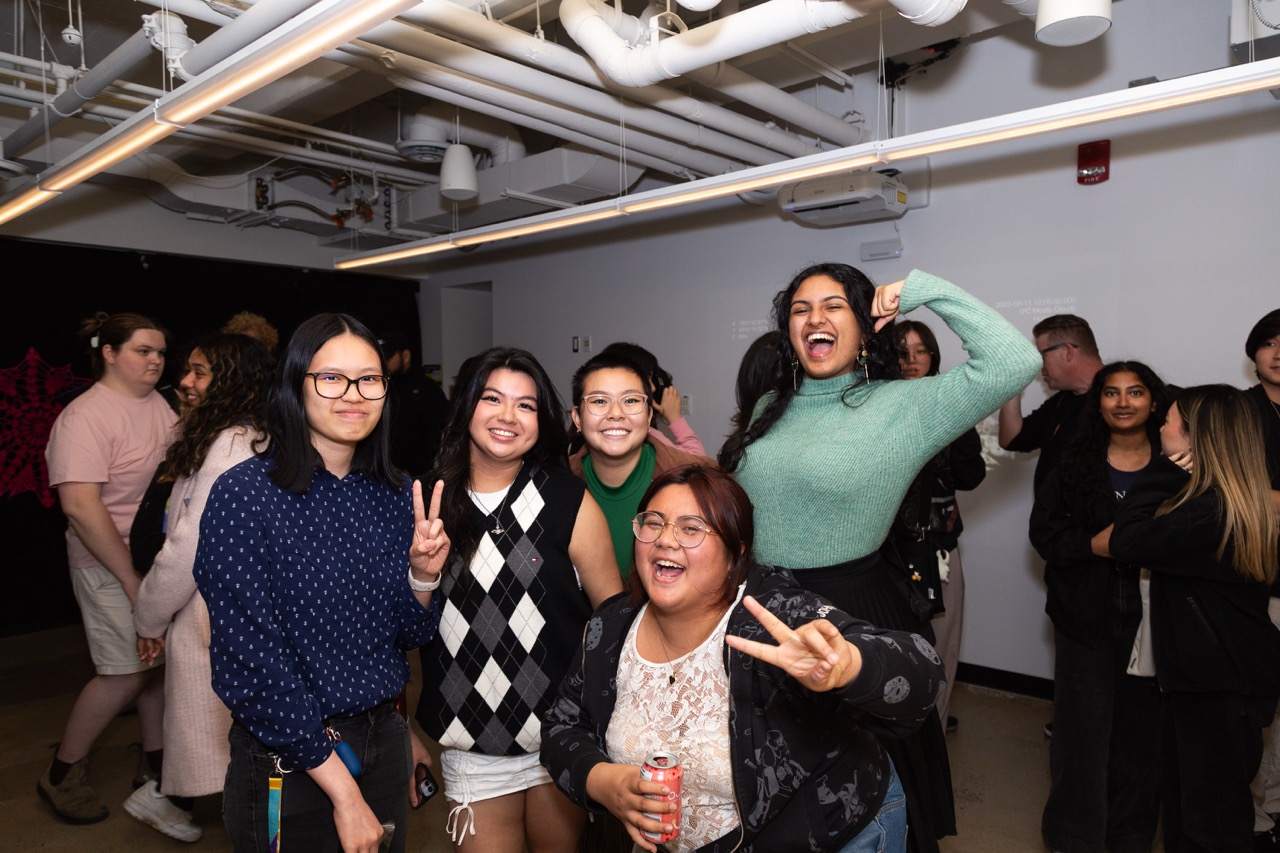 Madeline with the Exhibition Team posing in the gallery
