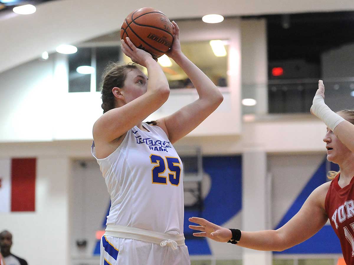 Female Rams basketball player shoots for a point