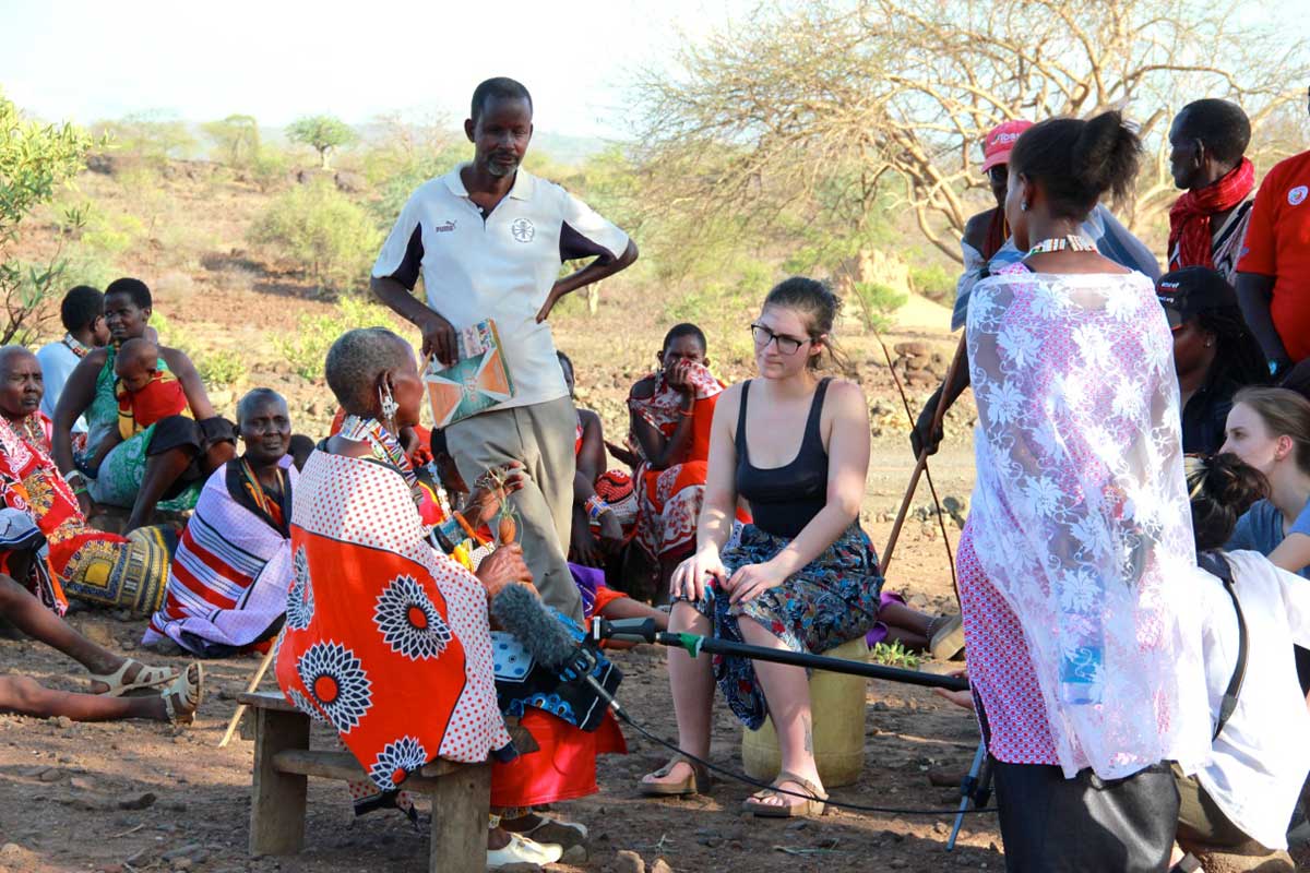 Female student interviewing Kenyan community members