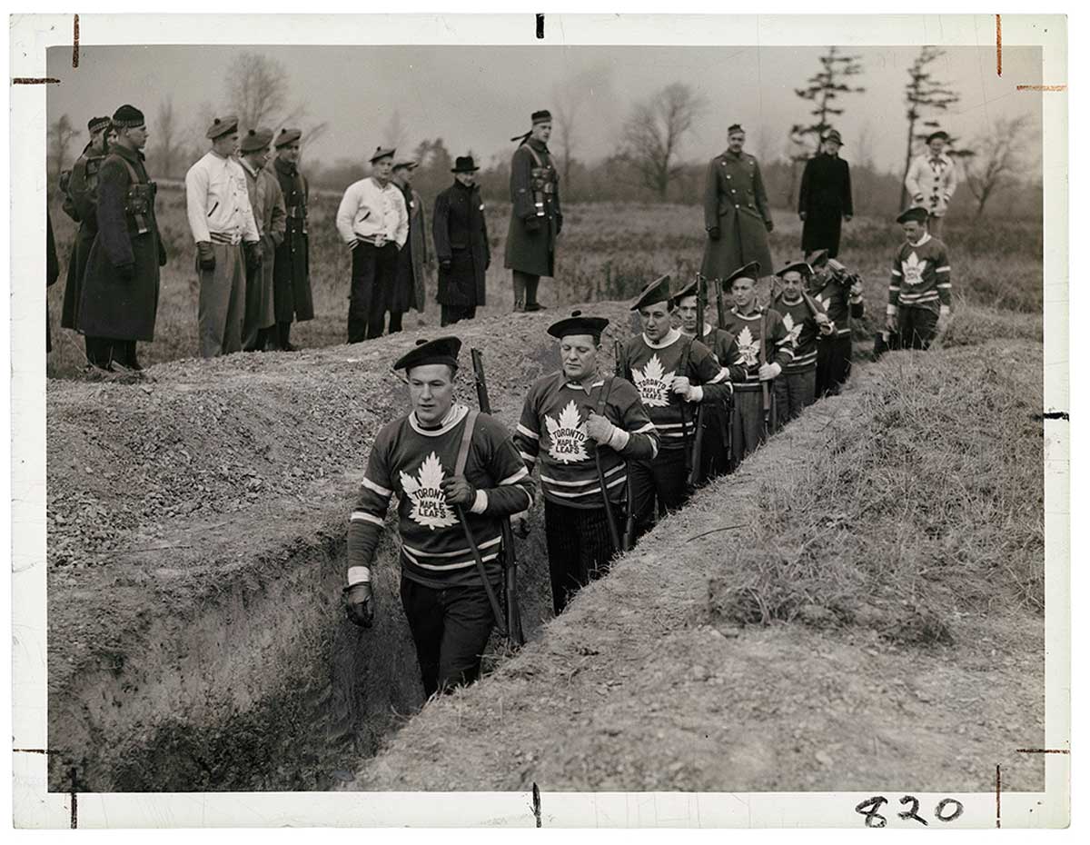 Unknown photographer for the Alexandra Studio. Distributed by the Star Newspaper Service and Times Wide World, Untitled [Members of the Toronto Maple Leaf hockey team in the trenches during a military training session], 1939, gelatin silver print. The Rudolph P. Bratty Family Collection, Ryerson Image Centre