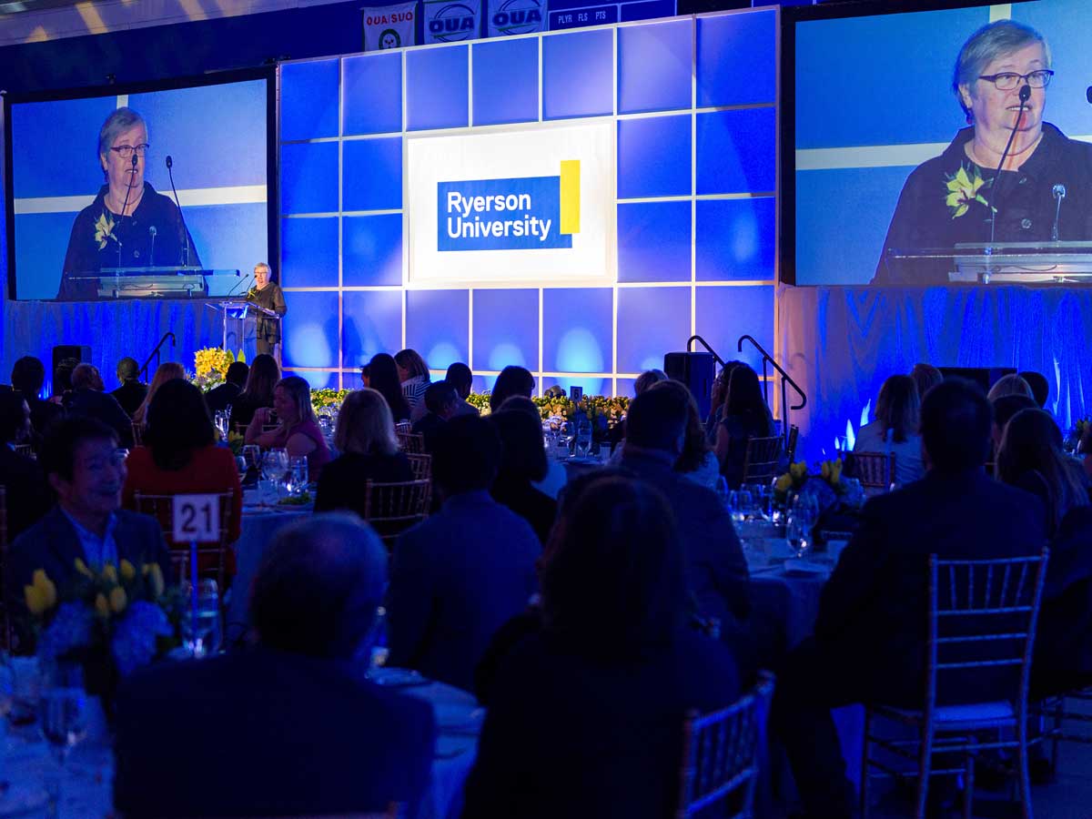 Bonnie Schmidt talking at podium on stage