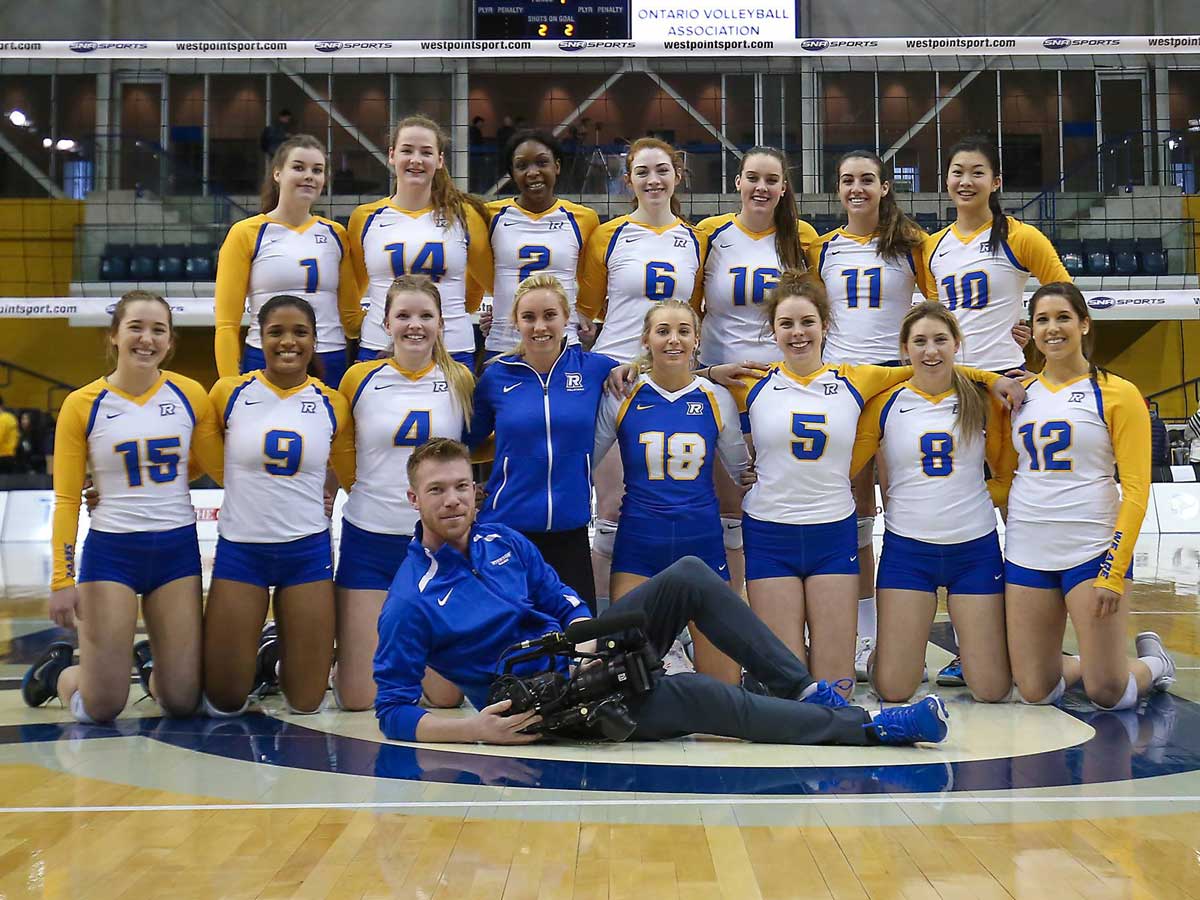 Elwin van Alst poses in front of Ryerson Rams women’s volleyball team