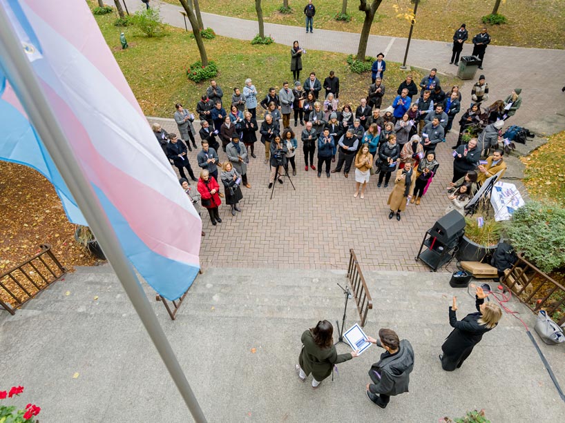 Community members gather at the trans flag raising