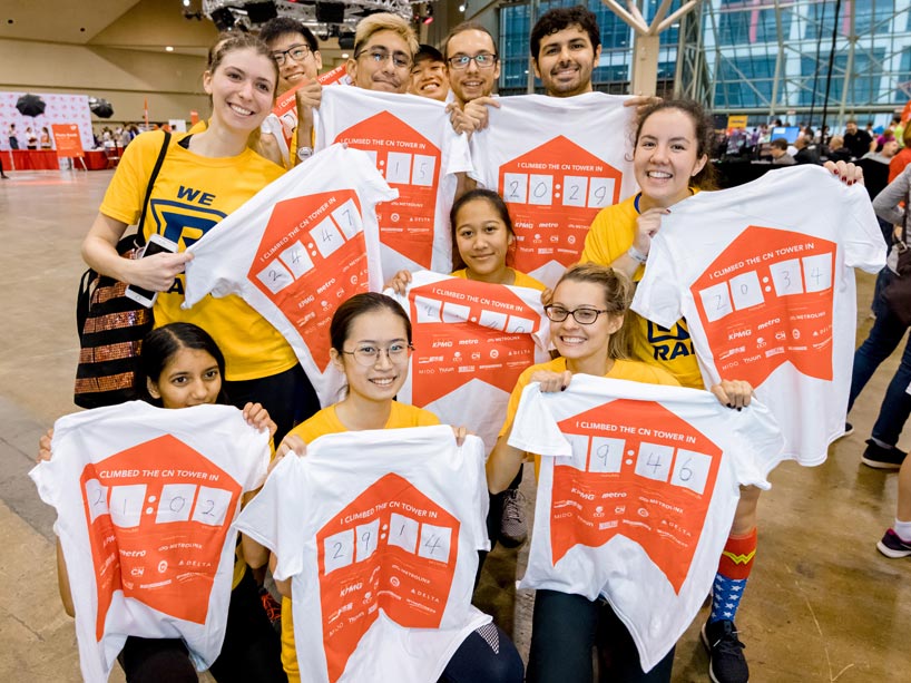 Fencing athletes showing off their times written on their t-shirts