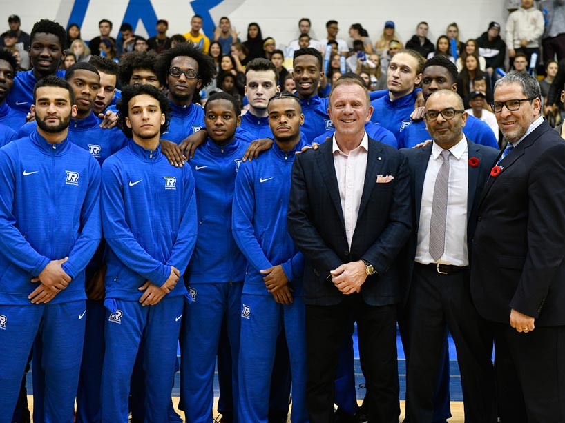 The Ryerson Men's basketball team with President Lachemi