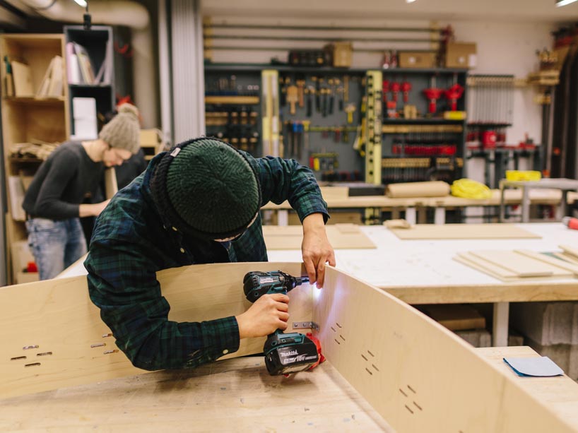 Student nailing pieces of plywood together