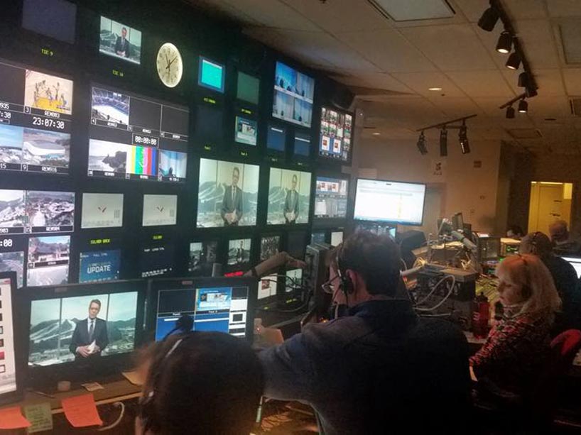 Technicians facing screens in the broadcast studio