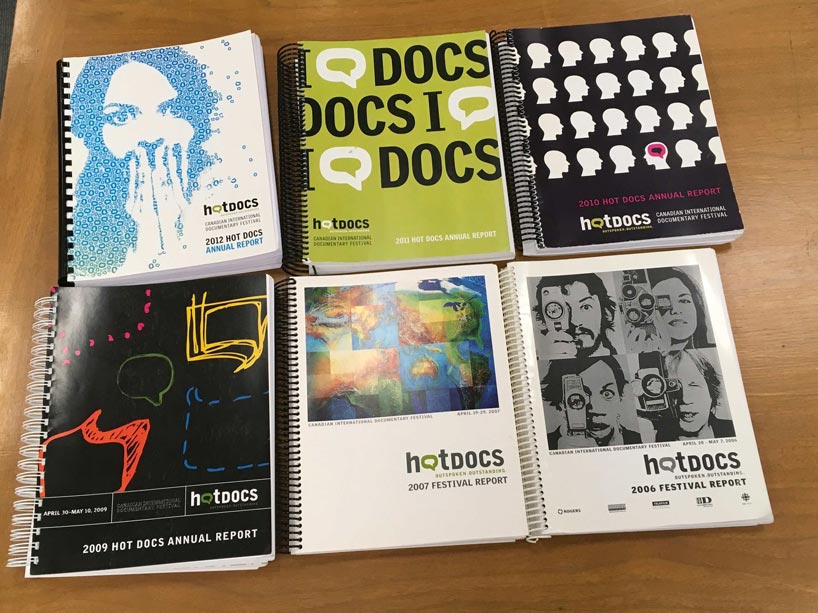 A selection of annual reports from Hot Docs on a table