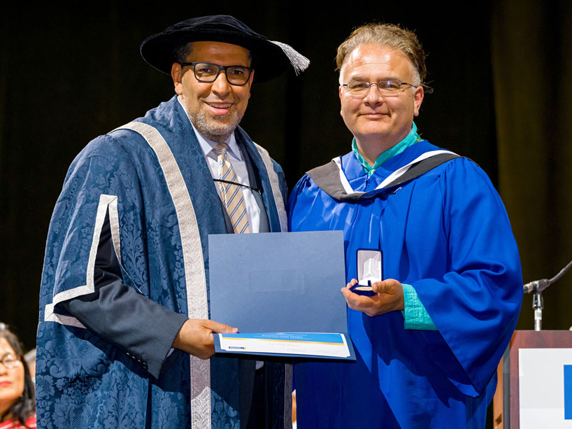 President Lachemi, left, presents Joseph Thomas Sayers with the Ryerson gold medal at convocation