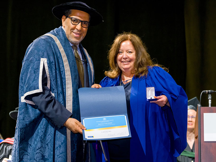 President Lachemi, left, presents Catherine May with the Ryerson gold medal at convocation