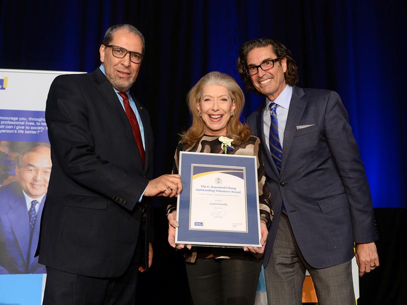 President Lachemi and VP Ian Mishkel present long-standing School of Fashion advisory council member Lynda Friendly with an award