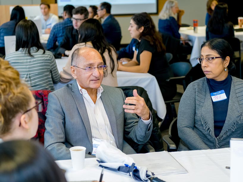Anver Saloojee, centre, sharing his immigrant experiences with people at his table