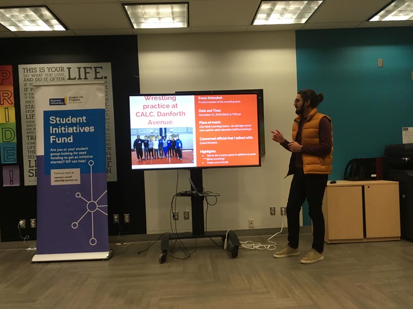 Abhi Raheja pointing at a screen, giving a presentation
