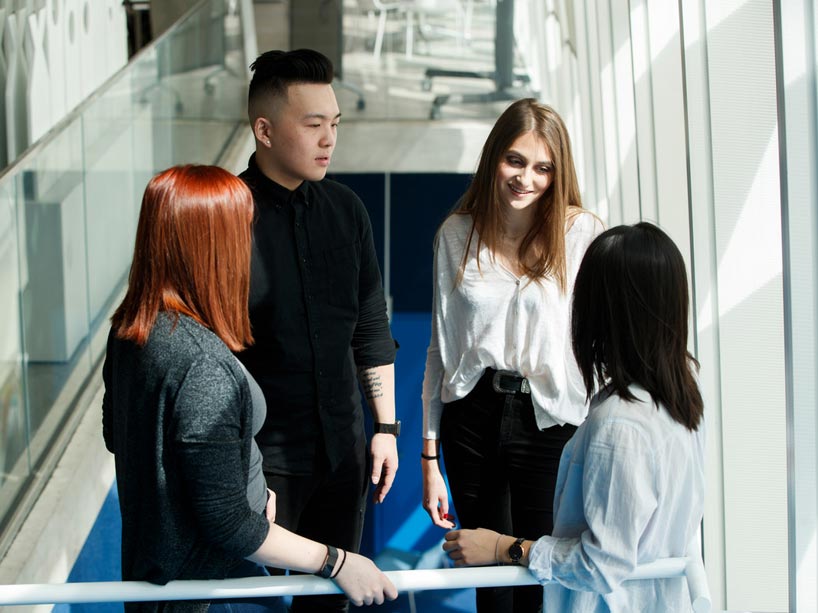 Four students talking to each other