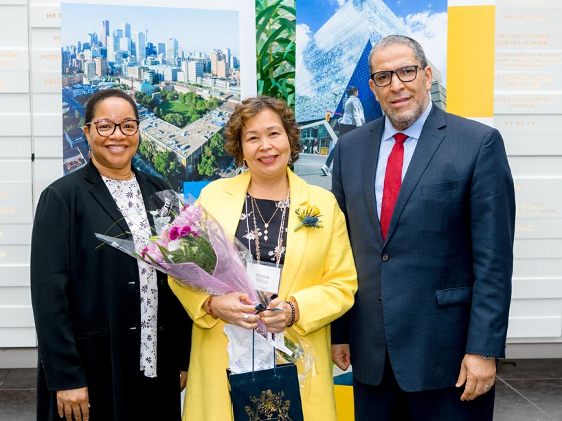 From left: Denise O’Neil Green, Monica McKay holding a bouquet of flowers and Mohamed Lachemi