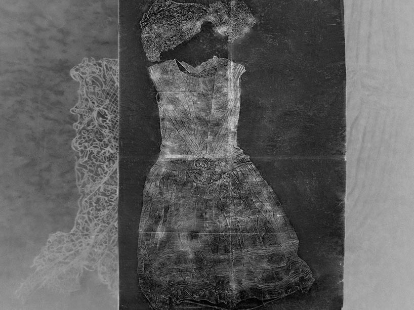A black and white photograph of an etched drawing depicting a wedding dress, veil and lace from 1927