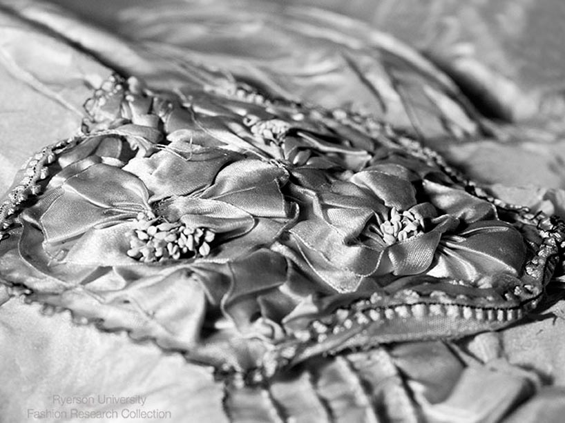 a close up of the round, silk ribbon rosette that decorates the centre waist of the dress