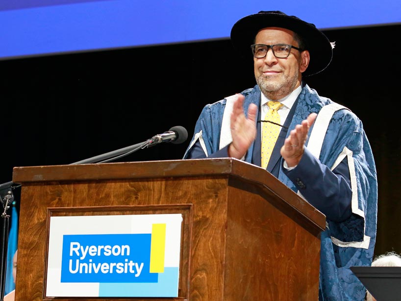Mohamed Lachemi clapping at the podium
