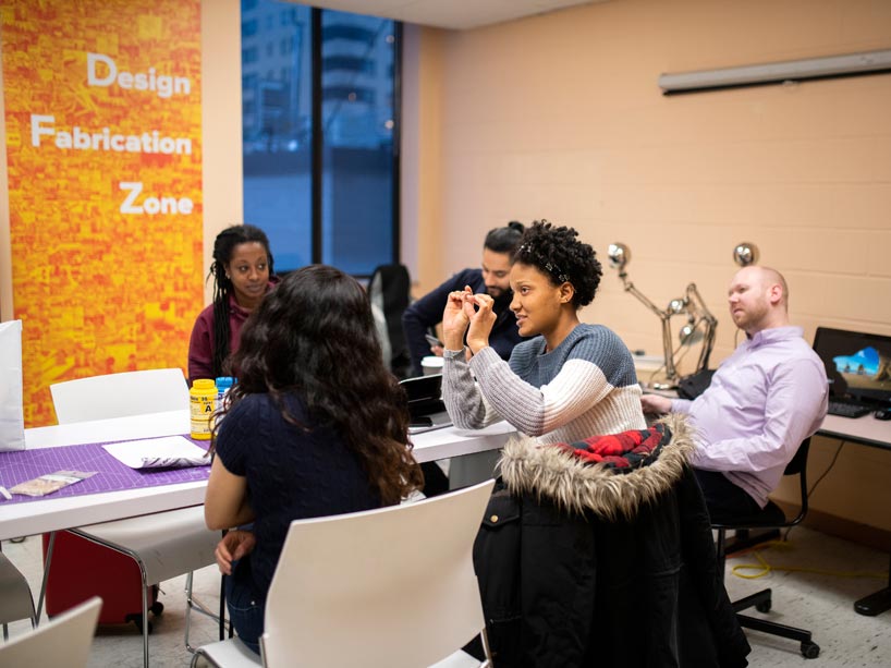Several people sit around a table 