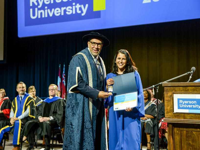 From left: Mohamed Lachemi and Annita Velasque Moreira, holding her award on stage