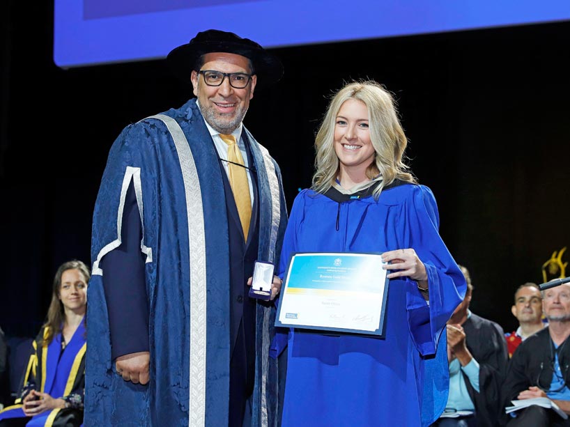 From left: Mohamed Lachemi and Sarah Oliver, holding her award on stage