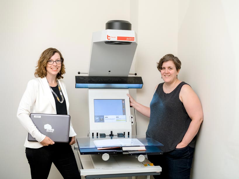 From left: Kelly Dermody and Kraigen Brown flanking a photocopy machine