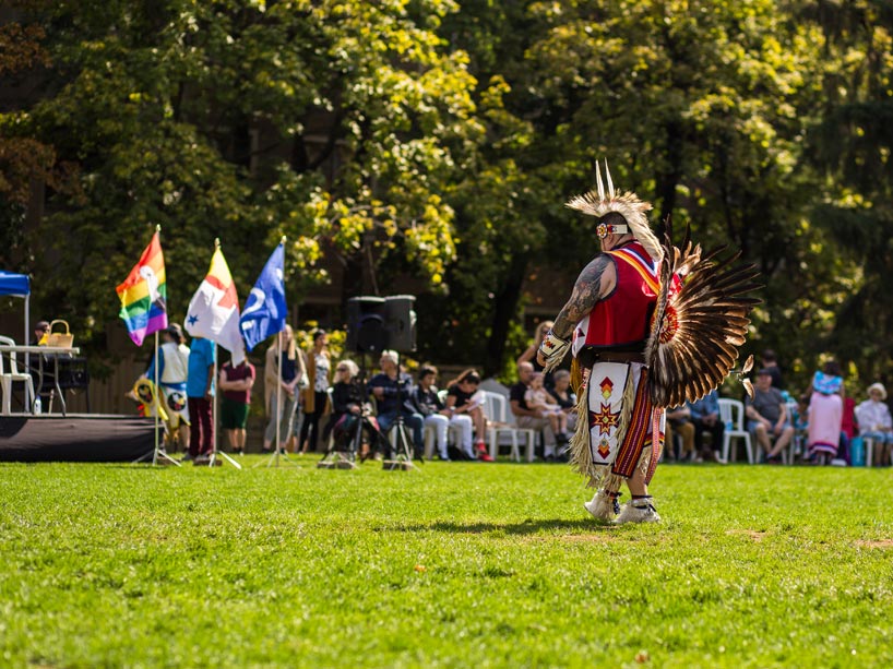 An Indigenous man wearing regalia