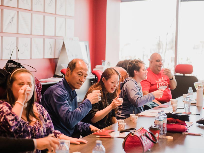 Five workshop participants take sips of water flavoured with fruit