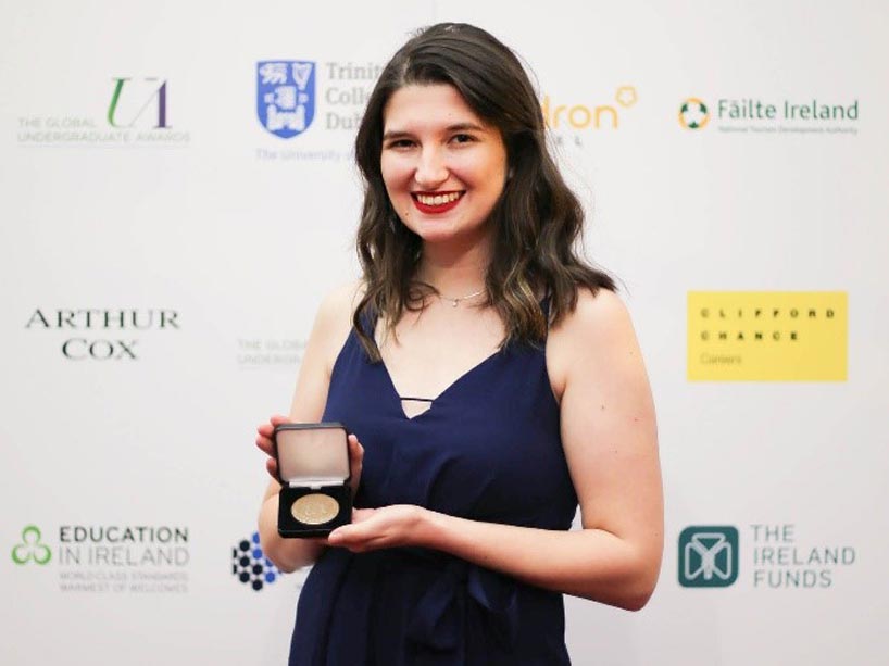 Laura DeSousa holding her award