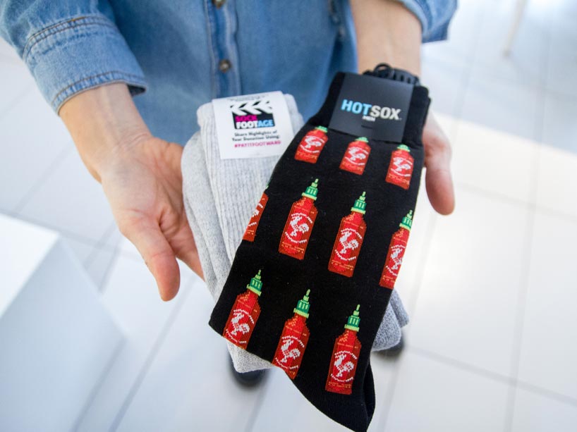 Pair of hands holding two pairs of socks