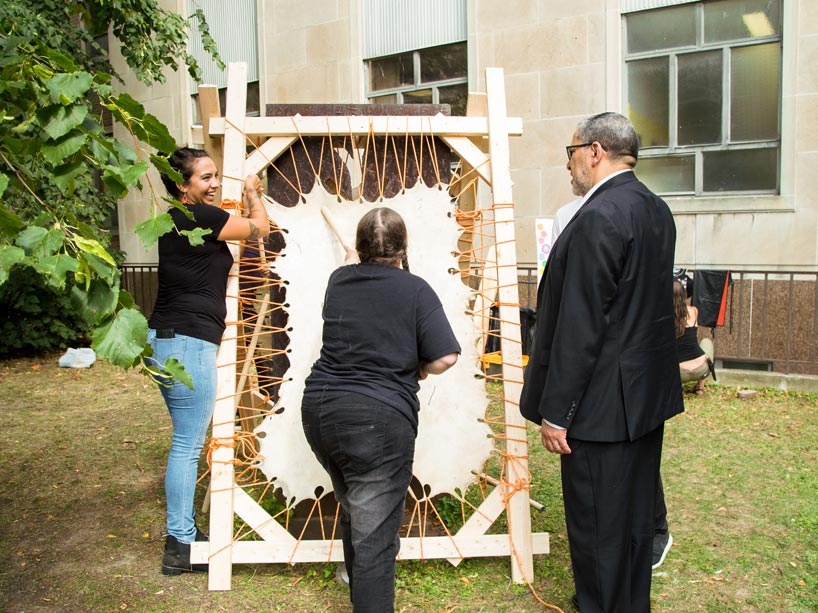 Amber Sandy showing Ryerson’s President Lachemi a tanned hide