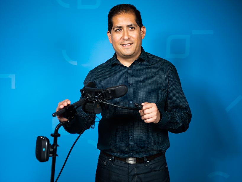 Mauricio Meza holds his electronic device.