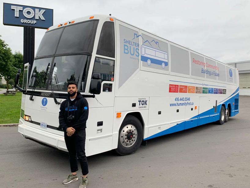 Burhan stands with the Shelterbus