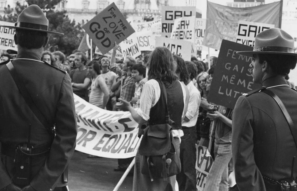 Protestors march with signs. 