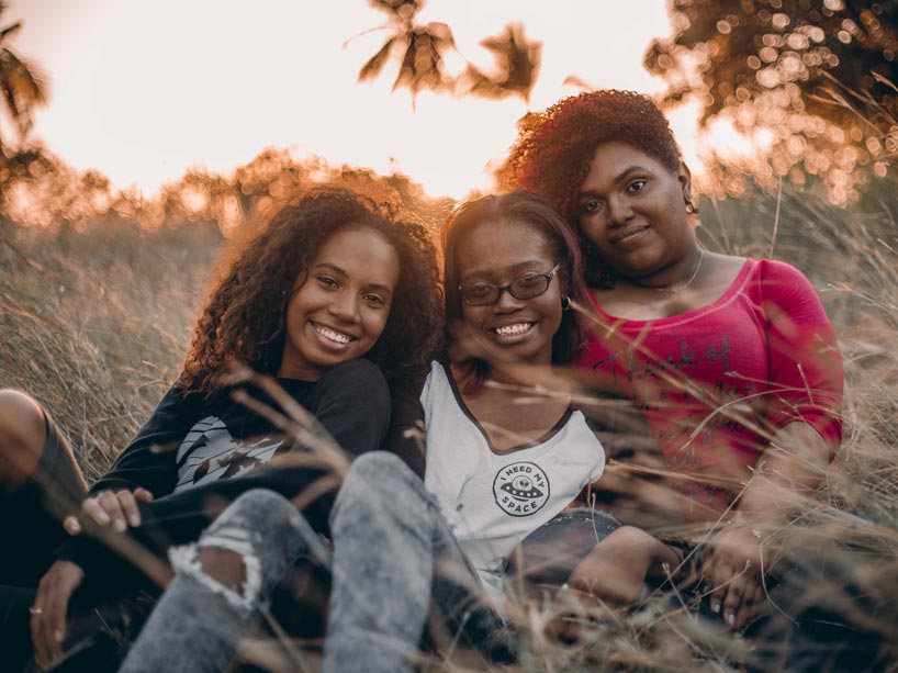 Three young Black women sitting together