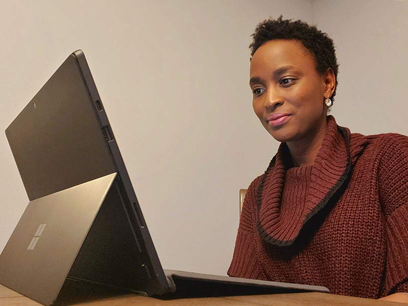 Luckrezia Awuor watches the fall 2020 virtual celebration on a laptop