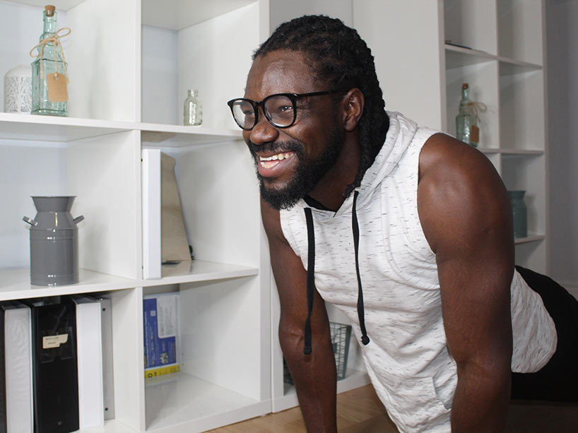 Student Kelly Imafidon poses on his exercise mat